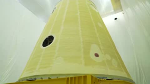 upward shot of large conical rocket adapter stage inside manufacturing or testing facility
