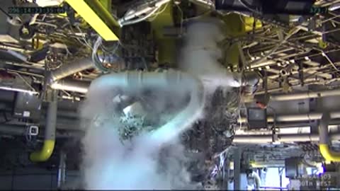 Close-up view of engine hardware and pipes shrouded in condensing vapor.
