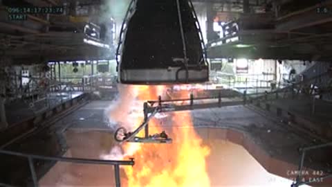 Interior view showing the ignition sequence and flames erupting in the test stand.