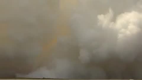 Exterior view of dense white smoke continuing to blanket the landscape.