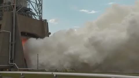 Exterior medium shot of white steam billowing from the test structure.
