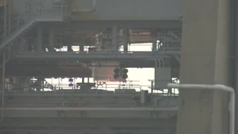 Static wide view of a control room interior or empty facility structure.