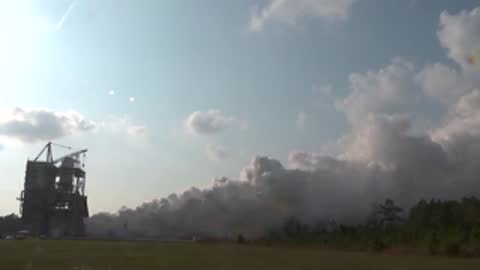 Medium view of exhaust smoke dispersing in the atmosphere.