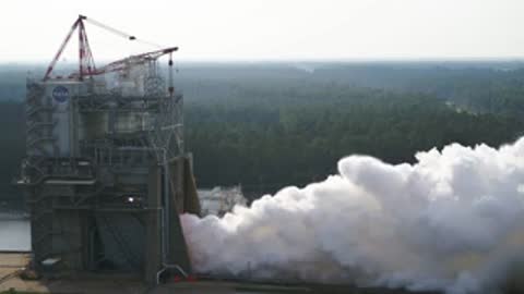 Wide view of the test stand operating with heavy exhaust smoke.