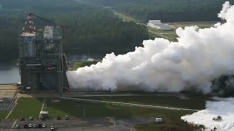 Wide aerial view of the test stand billowing white smoke.
