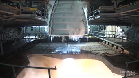 Medium view looking up at the rocket engine exhaust nozzle firing.