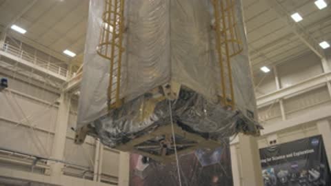 medium shot of the covered telescope element being lifted or lowered