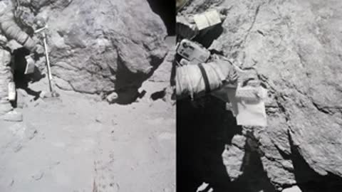 Archival footage of an astronaut working near large rocks on the lunar surface.