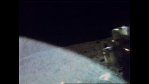 Archival grainy footage shows the moon's surface from a low angle.
