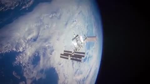 International Space Station orbiting Earth against blue planet backdrop.