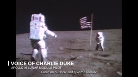 Apollo 16 astronaut saluting American flag on lunar surface
