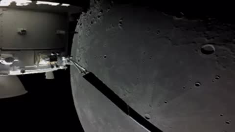 Partial moon phase viewed from spacecraft against black void.