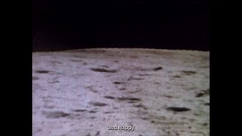 Archival footage panning across a rocky lunar landscape with craters