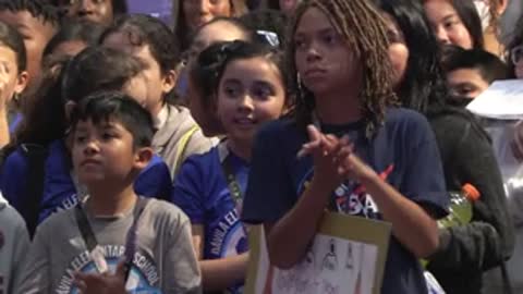 Children and teenagers clapping in an audience setting