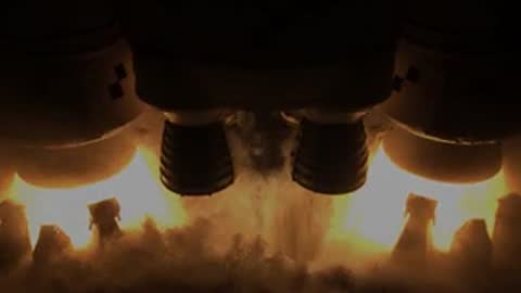 A rocket engine igniting and producing large flames and smoke