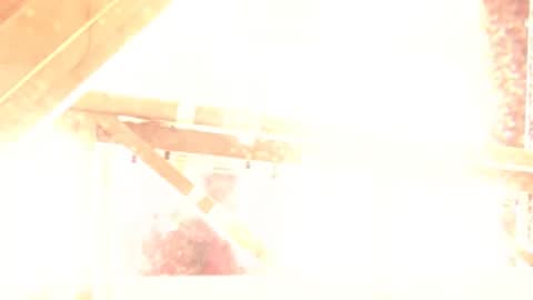 A rocket launching from a launch pad with bright fire and smoke