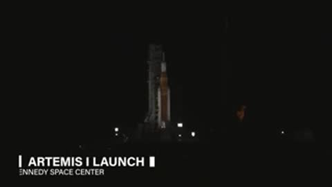 A large space rocket stands on a launch pad at night before launch.