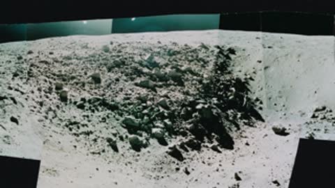 Rocky lunar crater floor covered in rubble and boulders