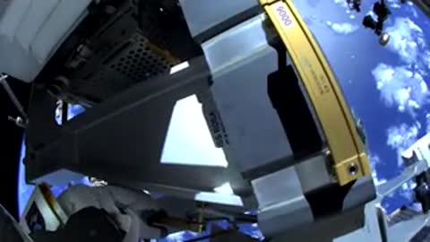 Astronaut training underwater near mockup structure, simulating lunar environment operations.