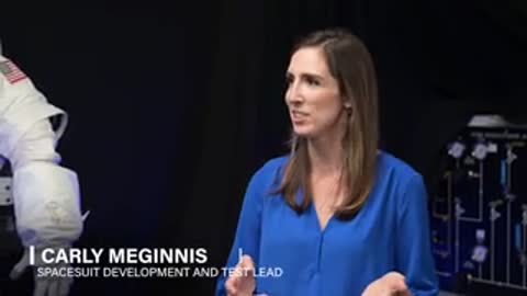 Woman in blue shirt speaks during interview in studio setting.