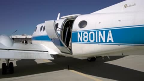 Close-up of the airplane door closing with N80INA registration visible.