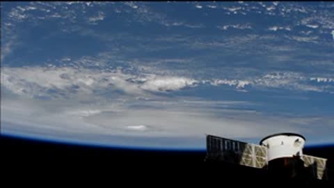 Space view of Hurricane Dorian moving across the ocean with clouds below.