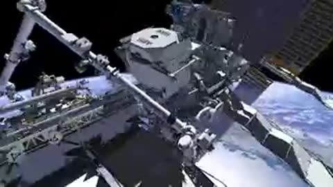 Close-up of robotic arm mechanism near station equipment.