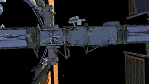Highlighted tool and astronaut near station truss.