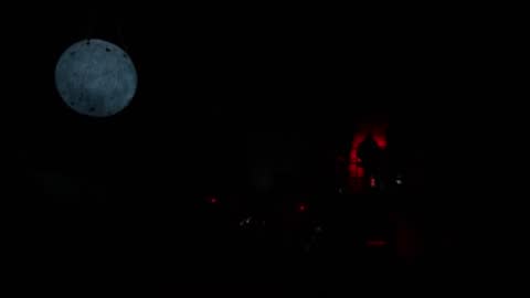 Glowing lunar model in dark room during training presentation.