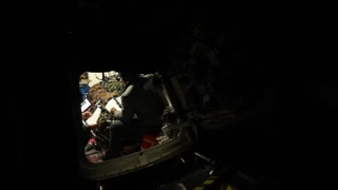 Distant view of vehicle simulator interior during training.