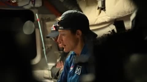 Close-up of astronaut wearing cap and headset in simulator.