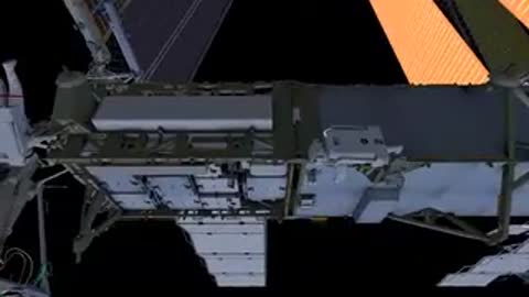 A distant view of the International Space Station orbiting high above the Earth.