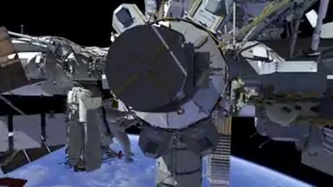 Wide view of the complex station structure with Earth curving in the background.