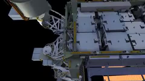 Overhead shot of astronauts moving near solar array