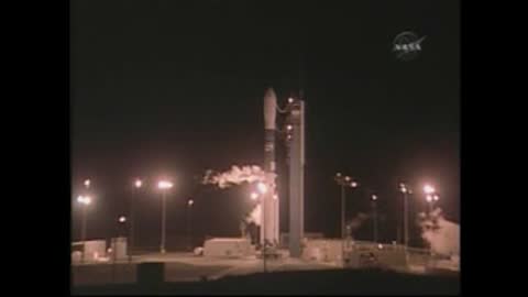 Static wide shot of a space rocket on the launch pad with venting smoke.