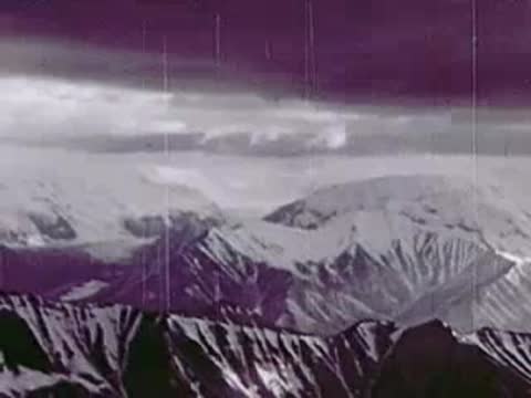Aerial view of snow-capped mountains and rugged terrain