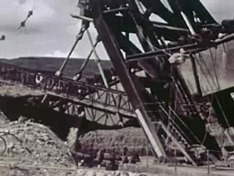 Large industrial mining machinery operating outdoors on uneven terrain