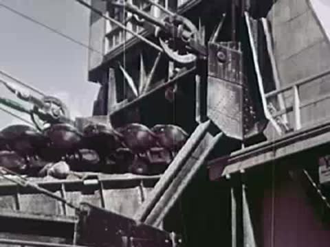Close-up of conveyor belts and buckets moving material in an industrial facility
