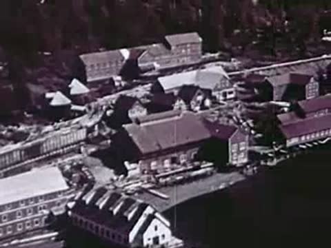 Aerial or high-angle view of a coastal settlement with buildings and roads