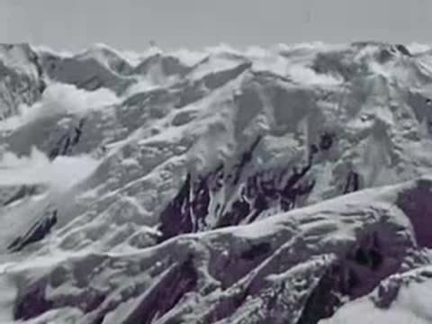 Rugged, snow-covered mountains and glaciers viewed from the air, Alaska, 1940s