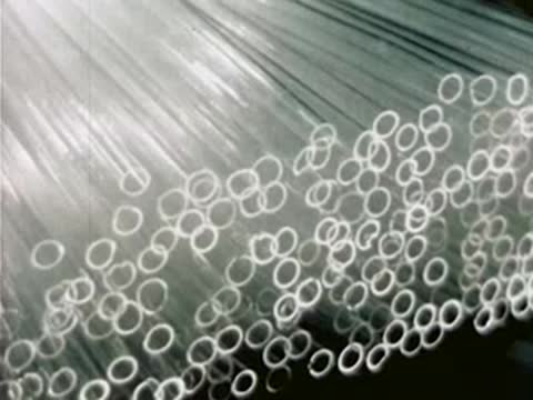 Stacked quartz glass tubing stored inside the factory manufacturing facility.