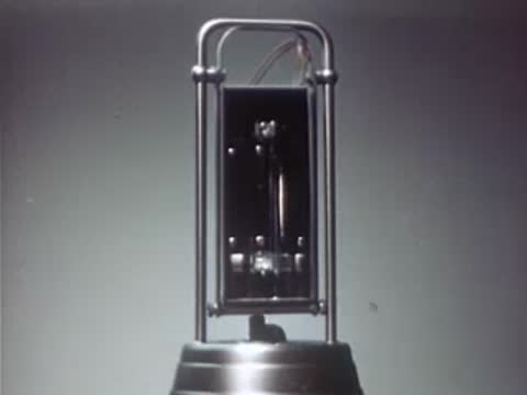 Ultraviolet lamp turning on with a bright blue light in a dark room.