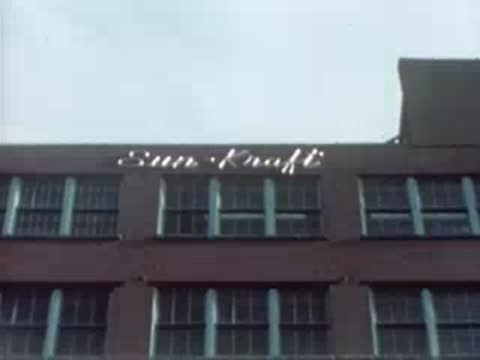 Exterior view of the brick building with the Sun-Kraft sign on the roof.