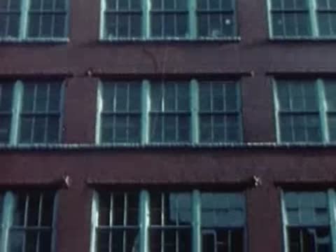 Facade of the Sun-Kraft Inc. building with multi-pane industrial windows.