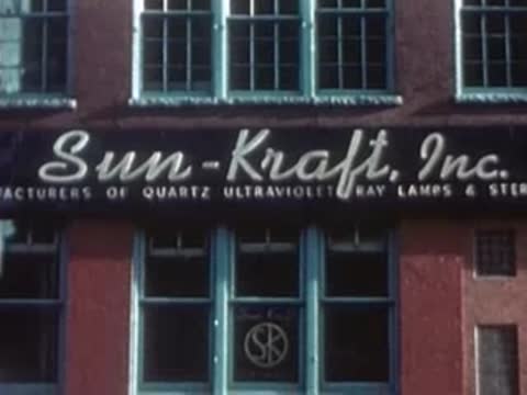 Entrance sign of Sun-Kraft, Inc. on a brick industrial building.