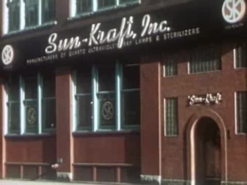 Sun-Kraft, Inc. brick building exterior with arched entrance and large windows.
