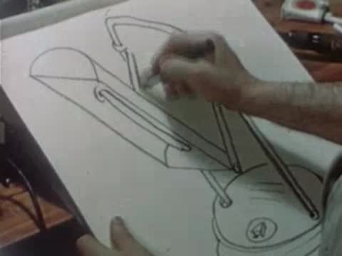 A hand sketches a drawing of a portable ultraviolet therapy lamp on paper.