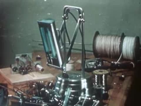 A portable ultraviolet therapy lamp sits on a workbench surrounded by tools and equipment.