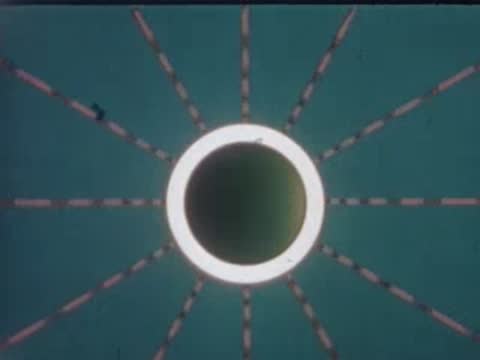 An animated graphic of a glowing circular light with radiating dashed lines.