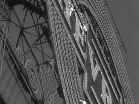 Close-up of a worker maintaining structural elements of a sign.